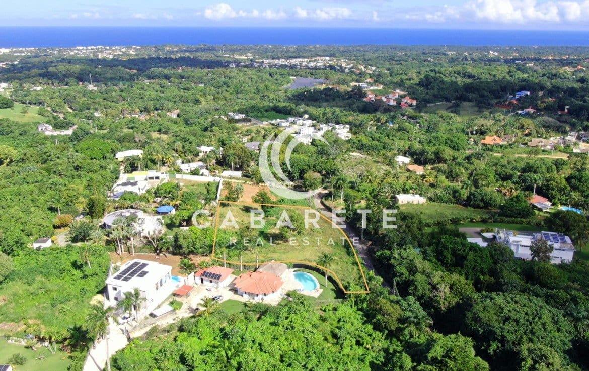 Well-positioned lot with level build site and sweeping vistas across treetops to the ocean.