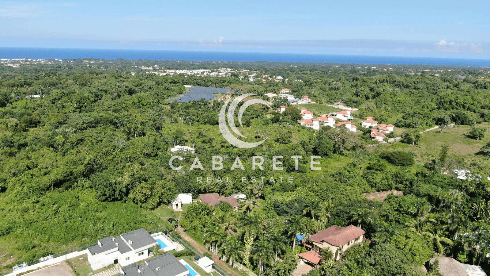 A spacious green lot surrounded by tropical trees, ideal for building a private villa near Cabarete Beach.