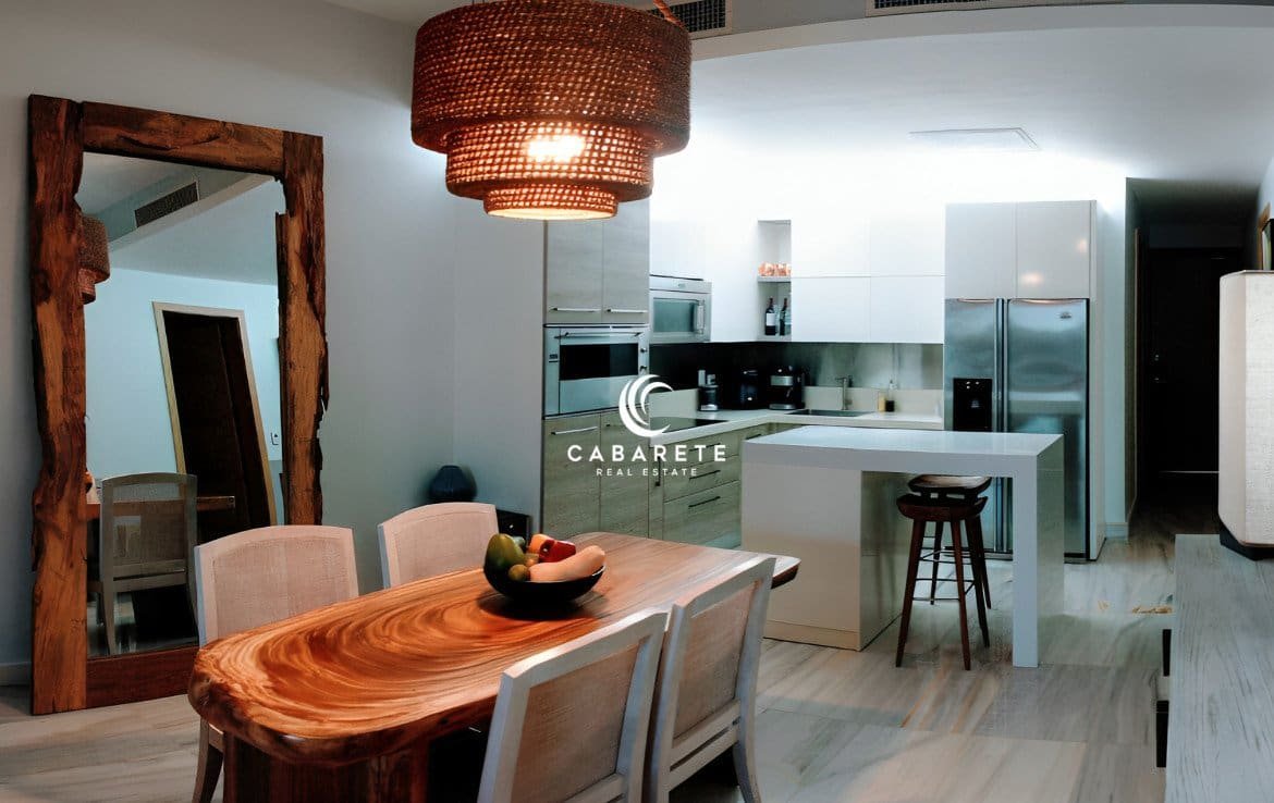 Second-floor beachfront apartment with palm-lined pathways, private terrace, and stylish indoor-outdoor flow