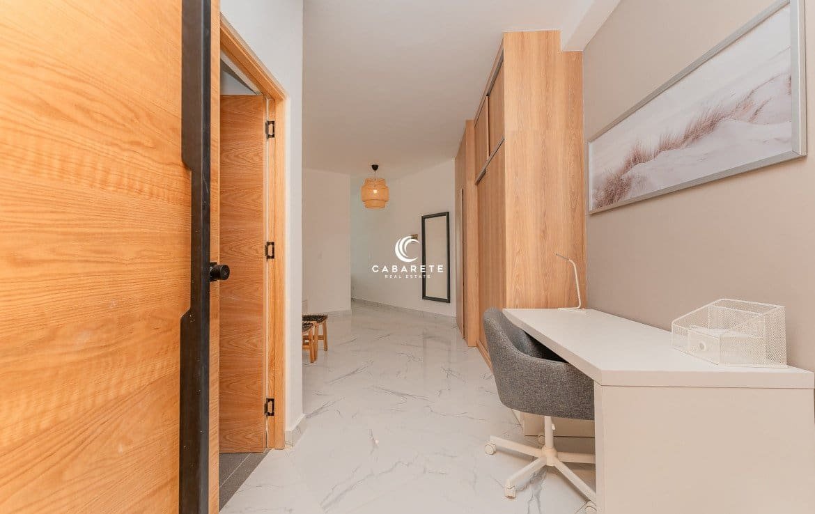 Modern hallway with a desk, a chair, and a closet.