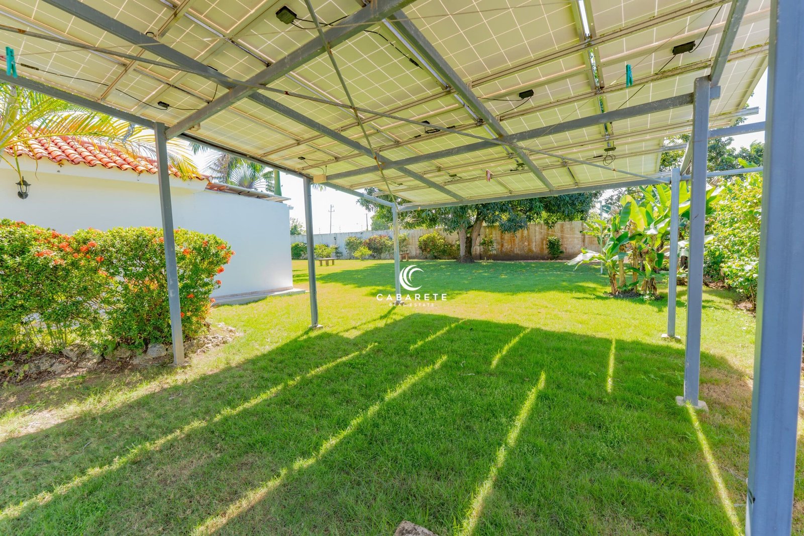 Spacious open-plan living area with vaulted ceilings and seamless indoor-outdoor flow. #OpenConceptVilla #TropicalInteriors #CabareteHomes