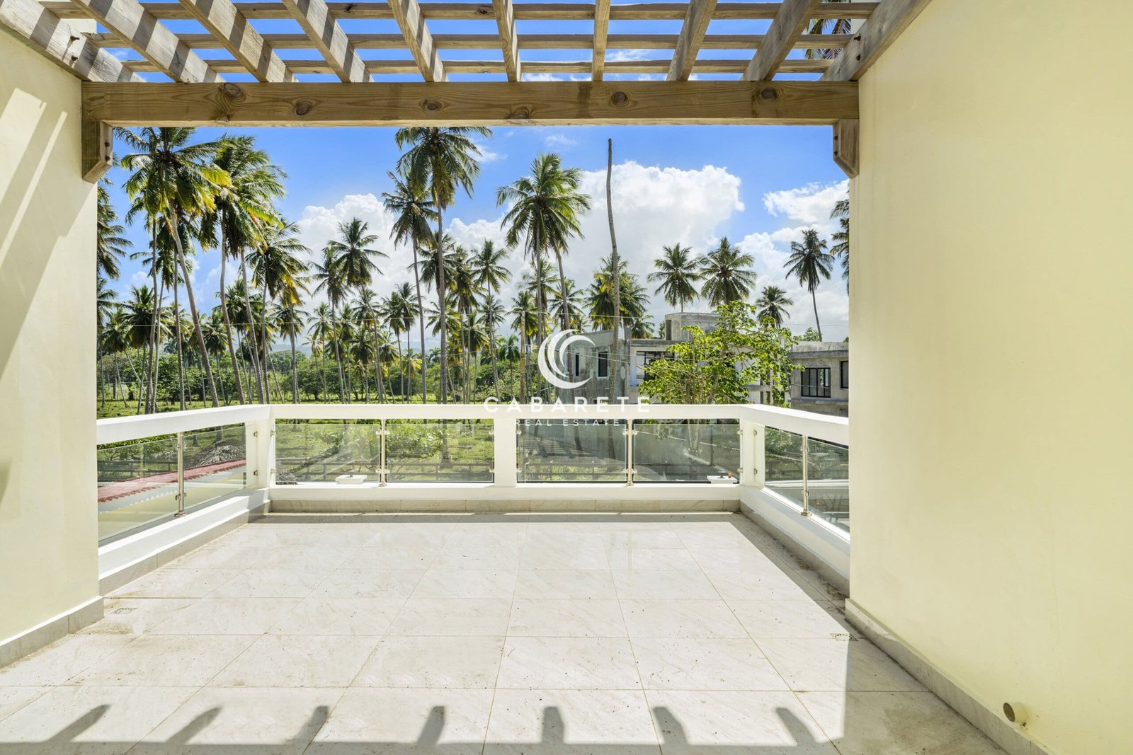 cabarete beachfront house patio views A panoramic view of Cabarete, Dominican Republic, showcasing beautiful oceanfront properties surrounded by lush greenery. The region’s diverse real estate options provide a perfect blend of luxury and nature.