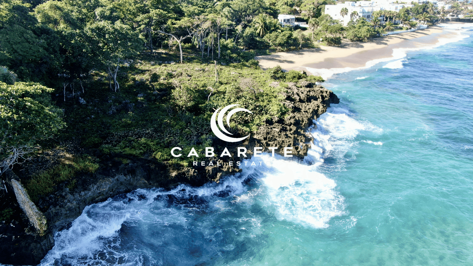 Aerial view of Playa Laguna’s beachfront land with ocean waves and tropical greenery