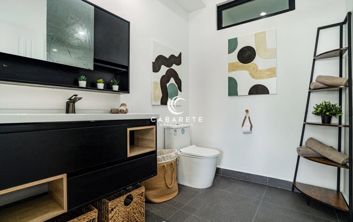 Modern bathroom in a Cabarete condo for sale with marble-style tiles