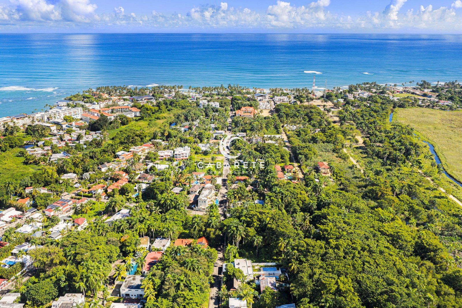 Land for sale in ProCab Cabarete located inside a gated community, featuring a flat buildable lot surrounded by tropical vegetation