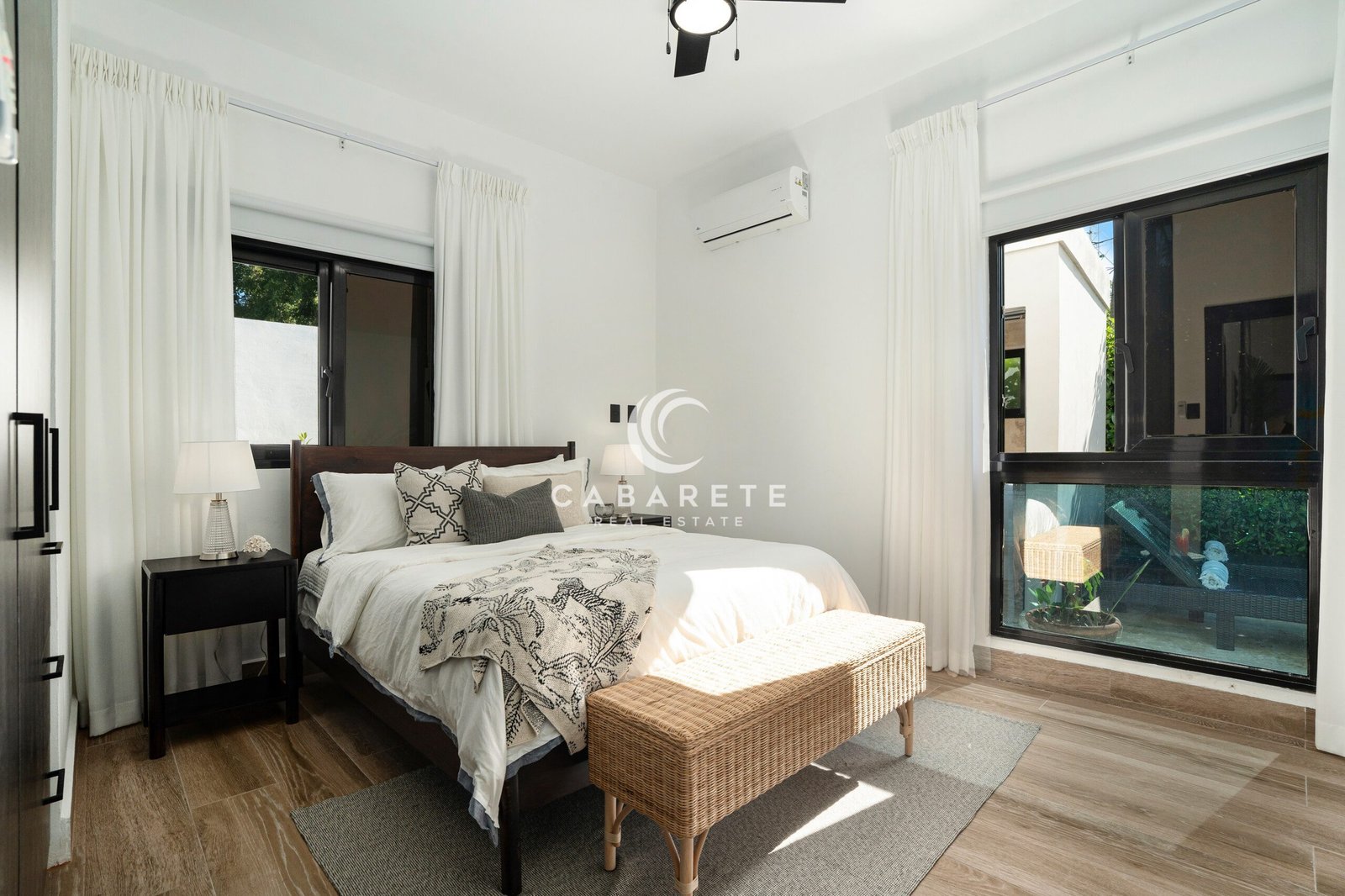 bright modern bedroom with black windows and wooden bed frame
