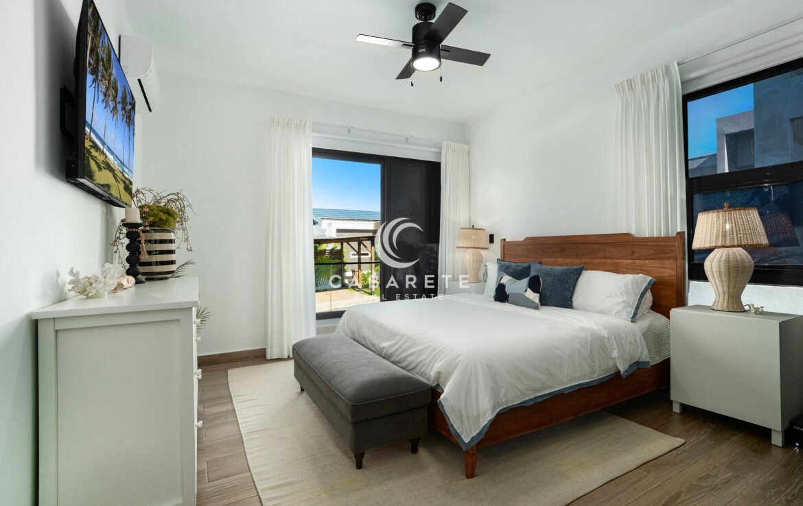bright modern bedroom with wooden bed balcony view