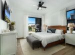 bright modern bedroom with wooden bed balcony view