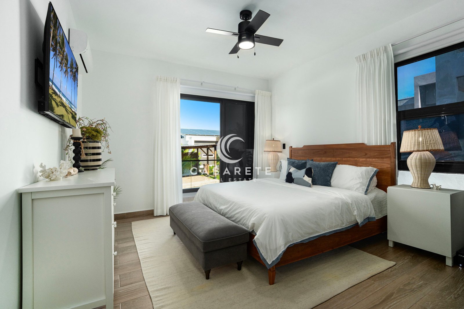 bright modern bedroom with wooden bed balcony view