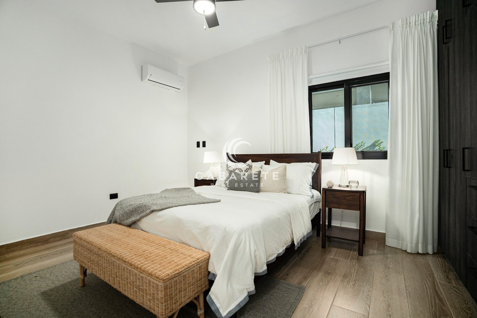 minimalist bedroom white linen bed wooden nightstands wicker bench
