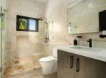 modern bathroom beige stone tiled shower rainfall showerhead