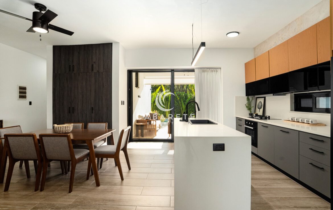 modern kitchen dining area with wooden table black faucet