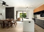 modern kitchen dining area with wooden table black faucet