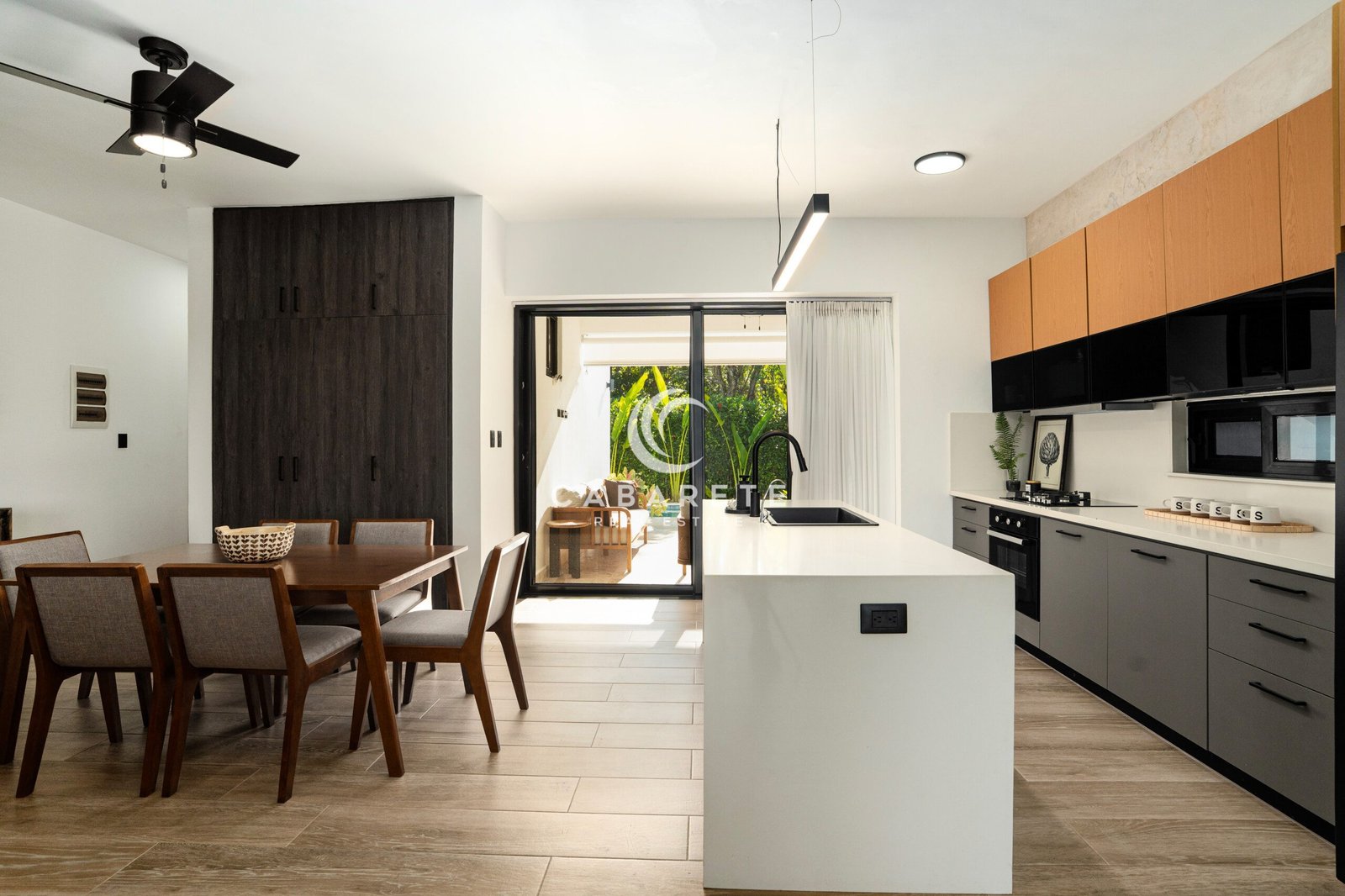 modern kitchen dining area with wooden table black faucet