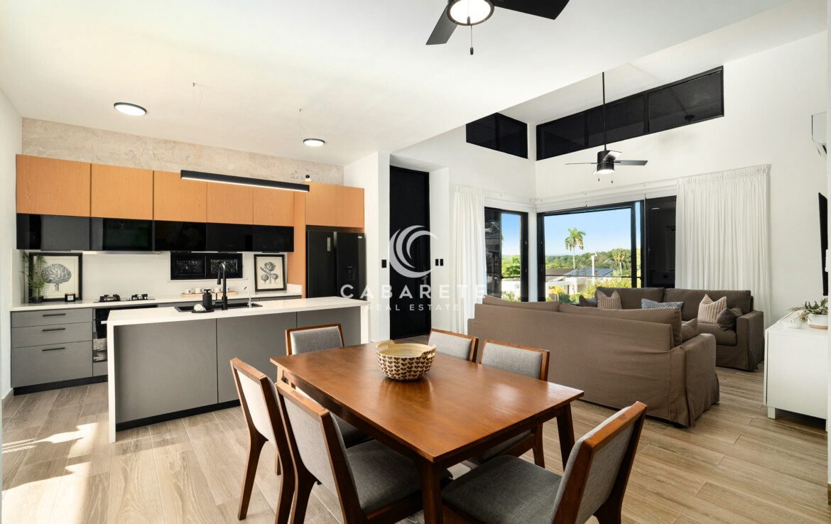 open concept kitchen dining living room with island and greenery view