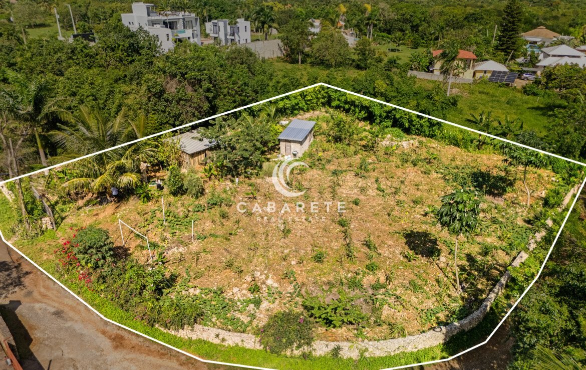Aerial shot showing irregular land with metal roofs and ocean dream apartment views