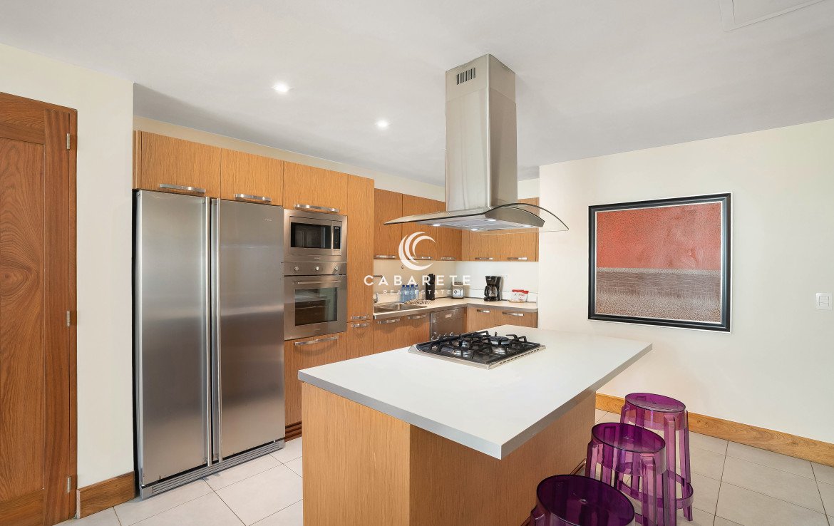 Modern kitchen with island seating in Cabarete luxury condo