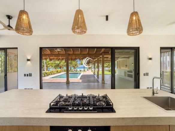 Contemporary kitchen with large island in luxury Cabarete villa